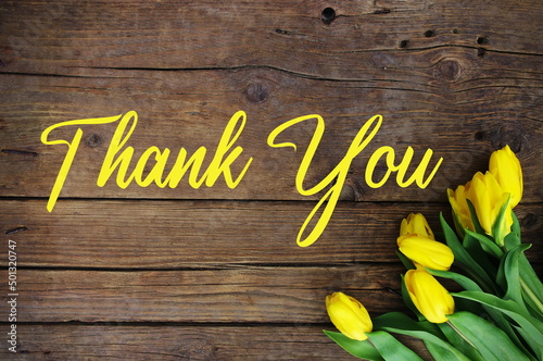 Thank You Message, Colorful tulips on wooden background. Spring flower background with blooming tulips, mockup template with copy space, backdrop for seasonal greeting card celebration. Mother's Day. 