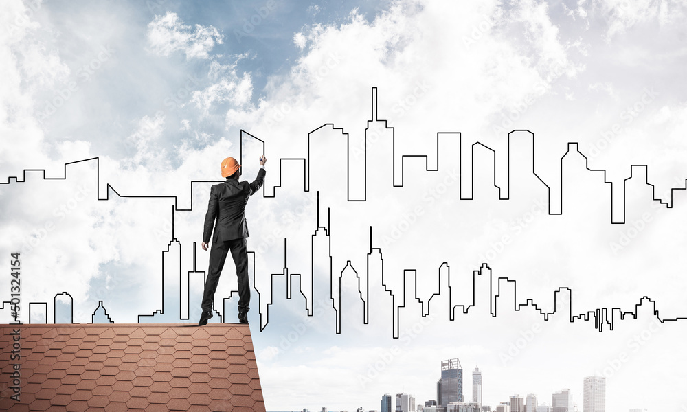Man architect draw silhouette of modern city on blue sky. Mixed Man architect draw silhouette of modern city on blue sky. Mixed