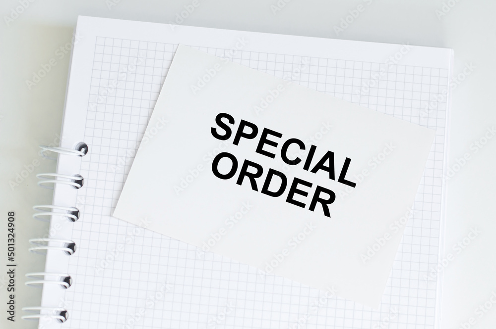 Special Order text on a white card that sits on a notebook on a table, a business concept Special Order text on a white card that sits on a notebook on a table, a business concept