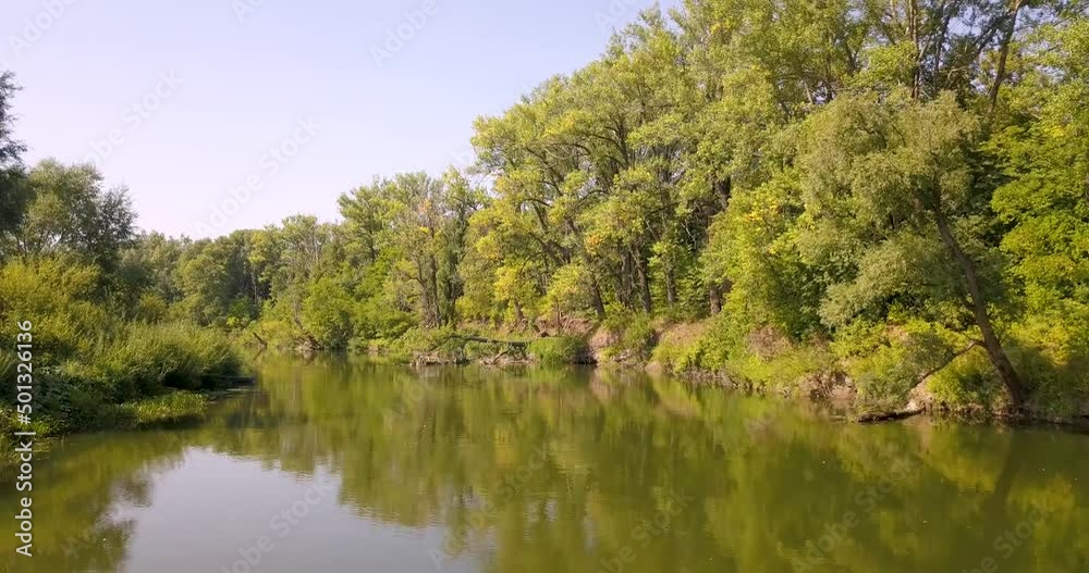 Aerial top view of a peaceful river valley among green plain. Summer scene and eco environment. Aerial top view of a peaceful river valley among green plain. Summer scene and eco environment.