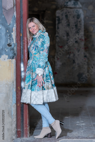 A beautiful woman in a winter suit in an abandoned castle. © nedomacki