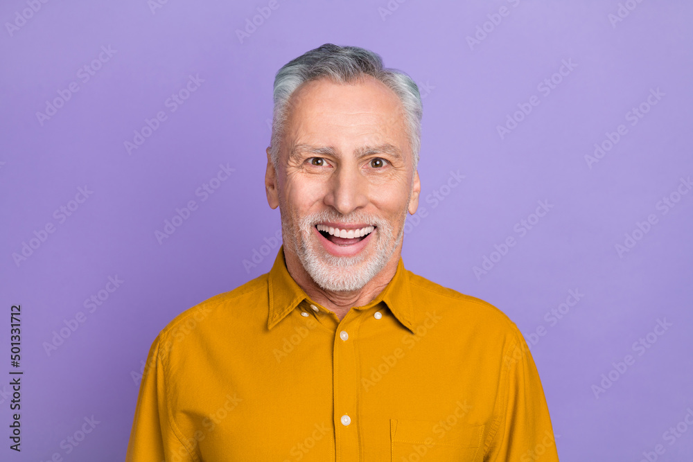Photo of funky elder white hairdo man wear yellow shirt isolated on violet color background Photo of funky elder white hairdo man wear yellow shirt isolated on violet color background