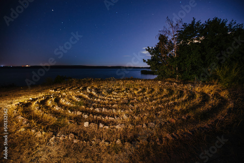 Spiral labyrinth made of stones on the coast, aerial view photo