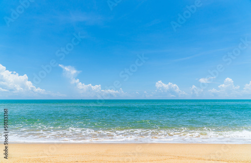 Sand beach seaside with with foamy wave from blue sea and blue sky clouds on daylight, landscape summer season travel 