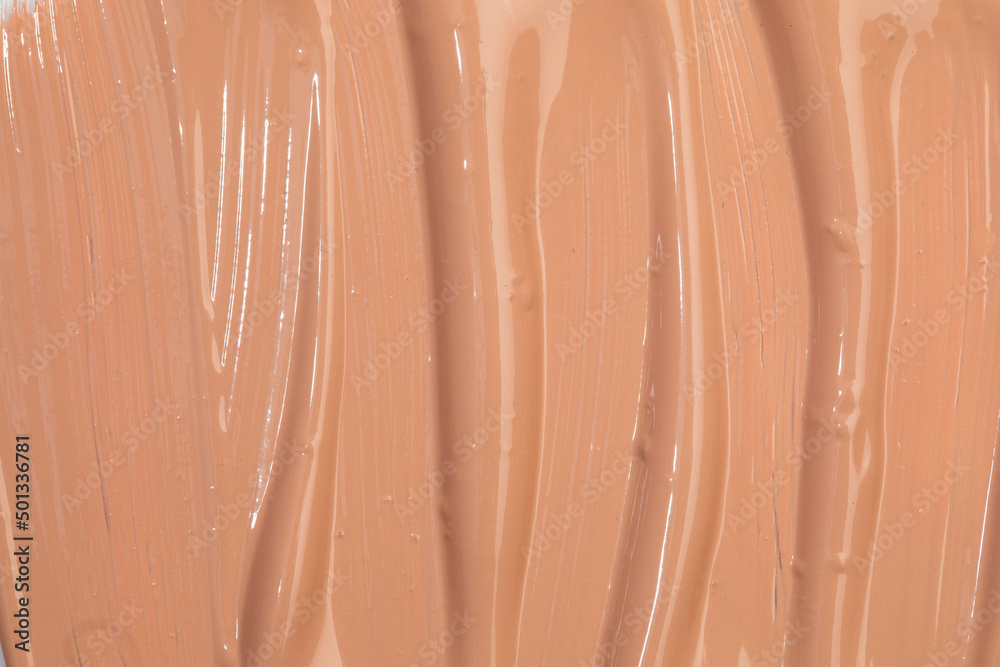Fototapeta premium Beige nude liquid foundation texture, concealer smear smudge drop. Closeup macro. Cosmetic tonal makeup moisturizer, bb cream swatch sample.- Image