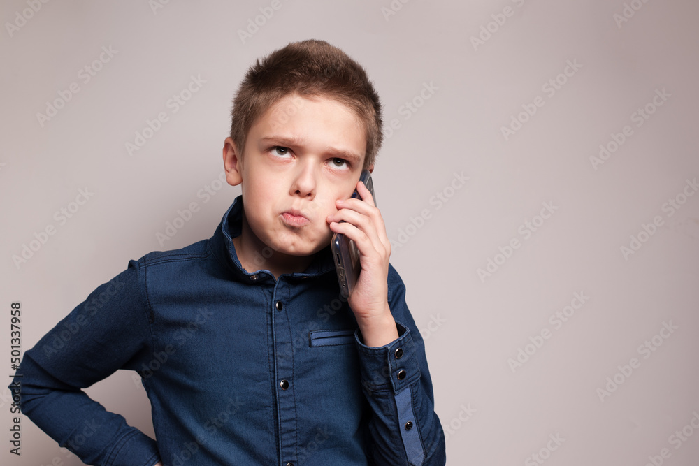 Portrait of teenage boy with smartphone in his hand Portrait of teenage boy with smartphone in his hand