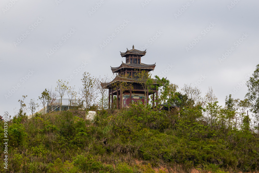 A pavilion in pagoda style of ancient Chinese architecture built on top of a hill A pavilion in pagoda style of ancient Chinese architecture built on top of a hill