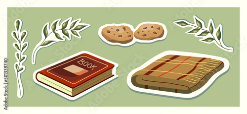 Cozy home set of items on the theme of reading. Book, blanket, and cookies.