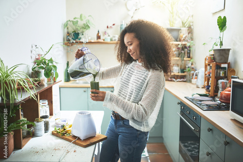 Young african girl preparing her healty smoothie