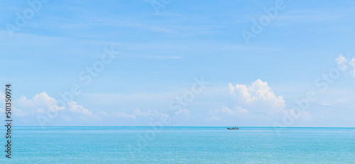 Canvastavla Small traditional fishing boat minimal on blue sea and sky clouds in summer seas