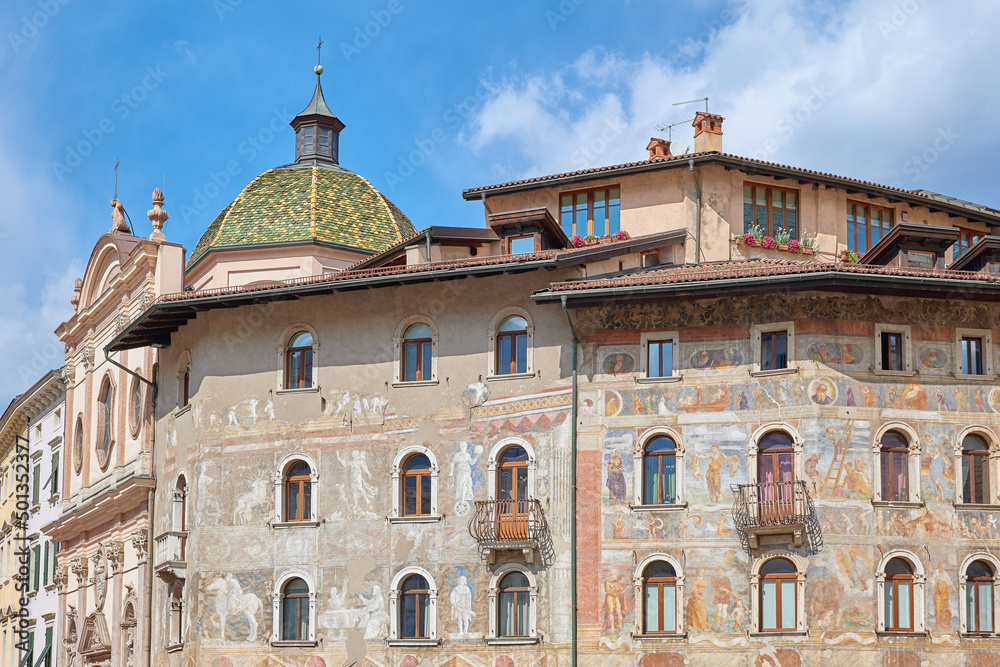 Historic building in the Duomo square in Trento, painted facade