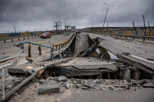 Fototapeta Naklejka Na Ścianę i Meble -  Hostomel, Kyev region Ukraine - 09.04.2022: Cities of Ukraine after the Russian occupation. Bridge over the river Irpin. The bridge was blown up to prevent Russian troops from passing through.
