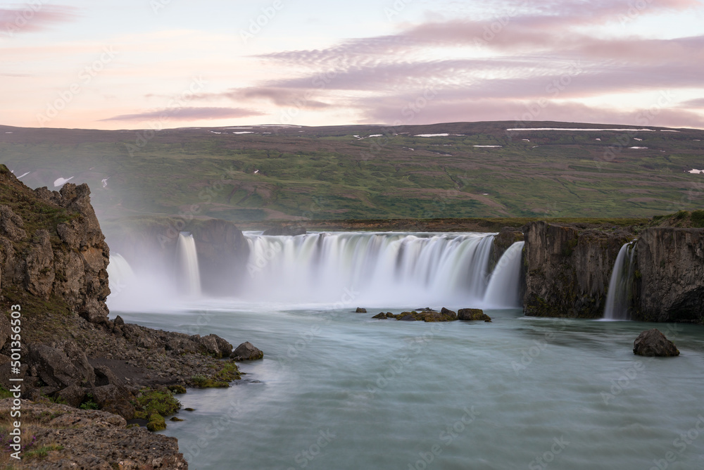Majestic waterfall in warm midnight sun light in summer. Godafoss, Iceland. Majestic waterfall in warm midnight sun light in summer. Godafoss, Iceland.