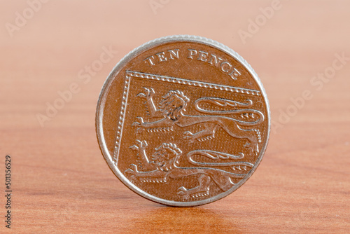 UK ten pence coin on wooden table.