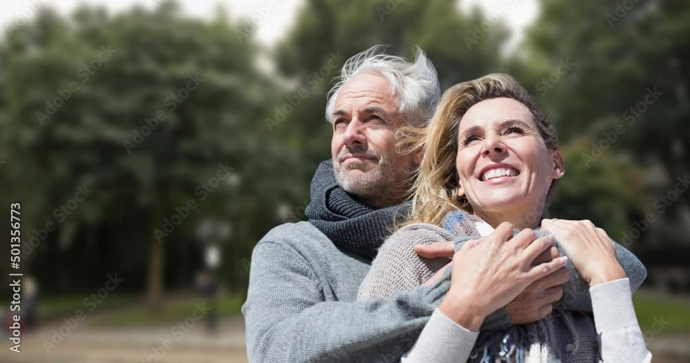 Animation of happy senior caucasian couple embracing over park Animation of happy senior caucasian couple embracing over park