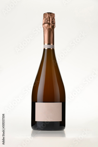 pink champagne bottle with blank label on isolated white background