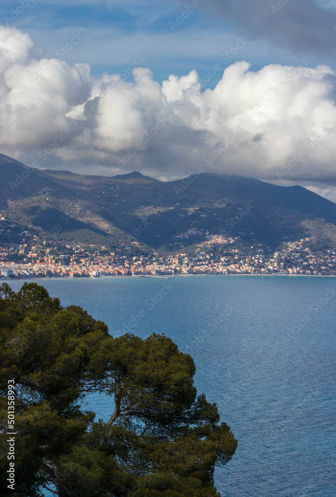ligurian coast seascape with mountain, sea and white clouds. ligurian coast seascape with mountain, sea and white clouds.