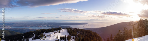View of Top of Grouse Mountain Ski Resort with the City in the background. North Vancouver  British Columbia  Canada. Sunset Sky