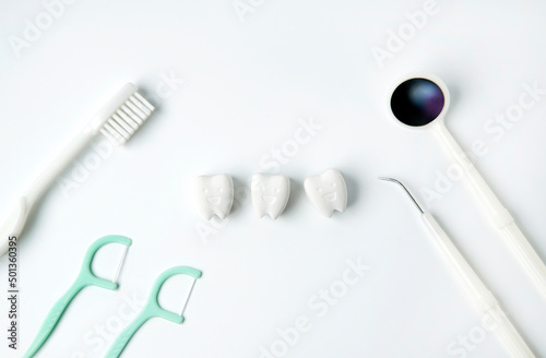 Healthy and whitening tooth with toothbrush, flossing and dental instrument on white background 