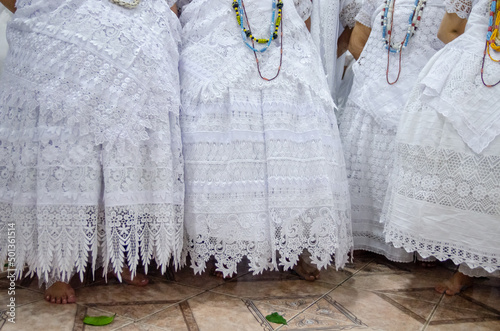 Detalhes de roupas brancas de mulheres em cerimônia no candomblé photo