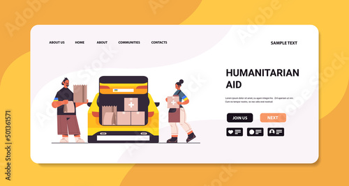 volunteer giving help boxes with Ukraininan flag to refugee humanitarian aid material assistance governmental help