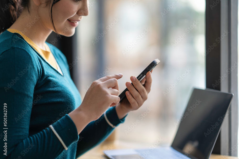 Asian business woman making a phone call and smiling indoor, During break from working in modern office. Mobile business technology concept Asian business woman making a phone call and smiling indoor, During break from working in modern office. Mobile business technology concept