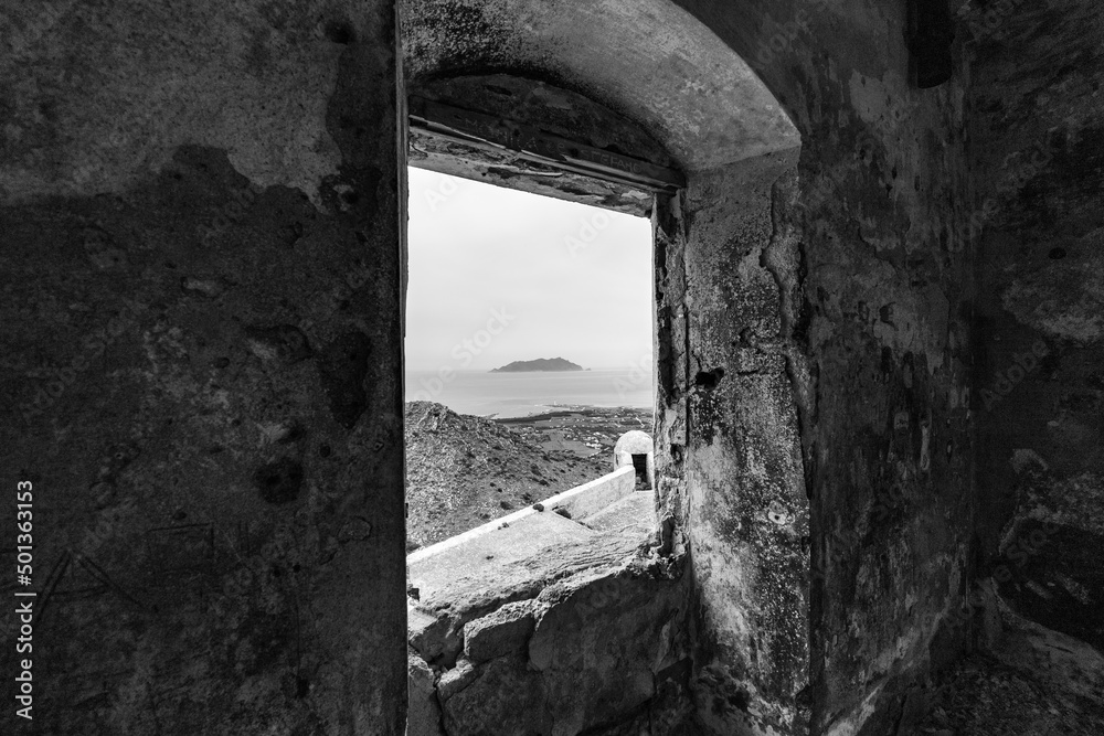 black and white photo of Levanzo island view trough the window of the castle of Santa Caterina, an ancient fort on the island of Favignana. (Egadi) Aegadian Islands, Trapani, Sicily, Italy