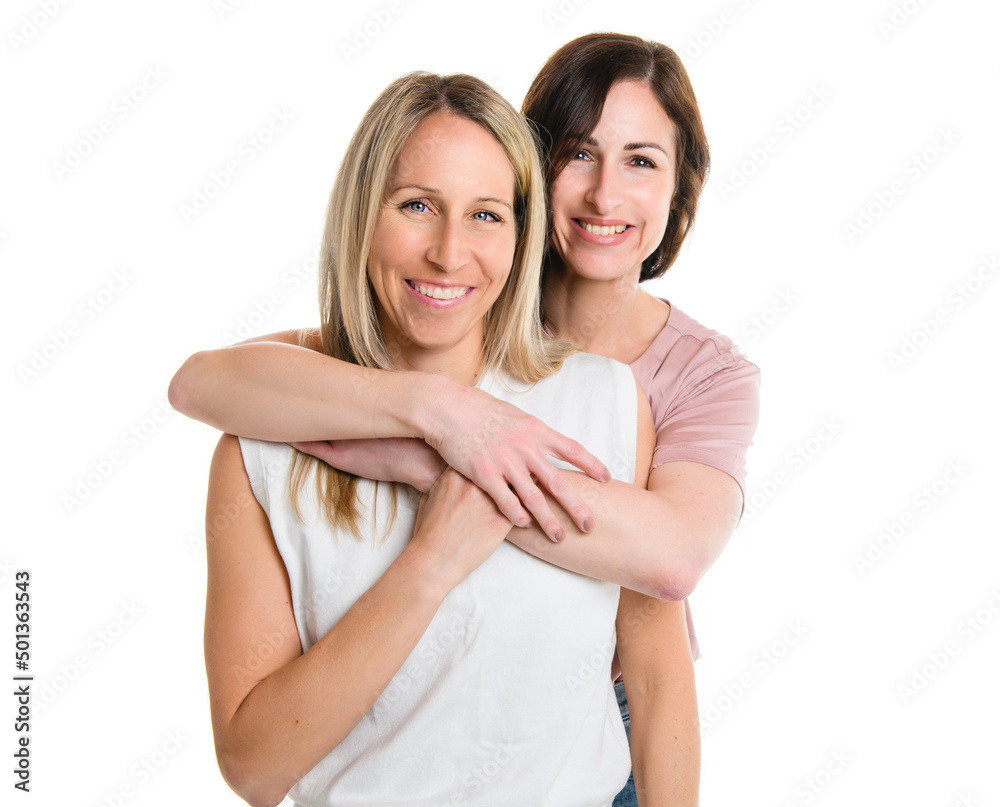 Two smiling best girl friends blond and brunette on white background. Closeup face portrait of two young beautiful women.