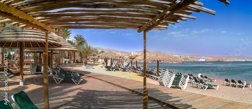 Concept of blessing and happy vacation. Panorama of relaxing public beach of ...