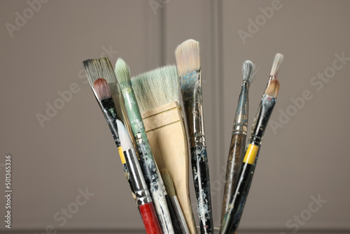 Set of different paintbrushes on grey background, closeup