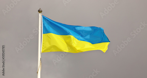 Ukraine national flag waving in wind against cloudy sky. Ukrainian Flag on flagpole flapping