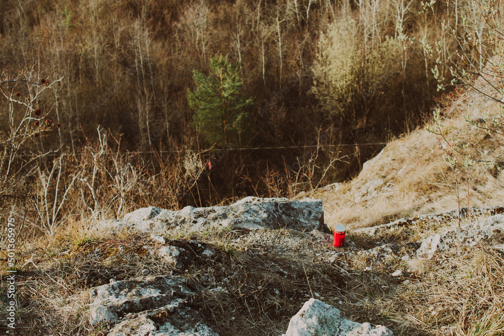 View from the edge of the rock with a red candle. Conceptual photo. View from the edge of the rock with a red candle. Conceptual photo.