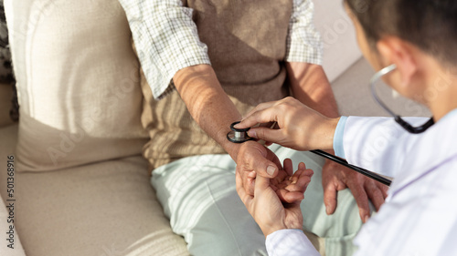 Doctor hold stethoscope listen to elderly patient heart in hospital.