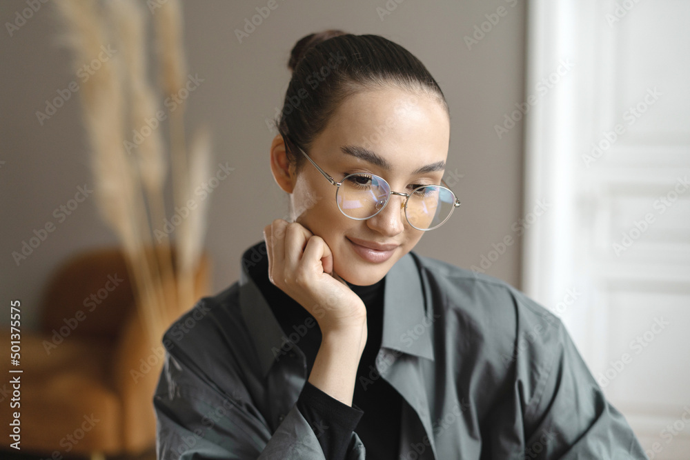 Portrait of a woman with glasses manager working in the office. Company Report Portrait of a woman with glasses manager working in the office. Company Report