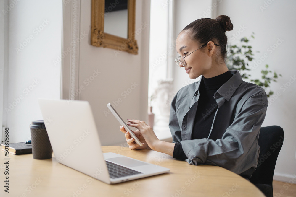 A female freelancer works with glasses, uses a laptop, writes a reply message to the client by mail. Company Report A female freelancer works with glasses, uses a laptop, writes a reply message to the client by mail. Company Report