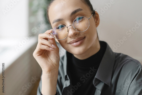 A woman with glasses is a manager working in an office. Company Report