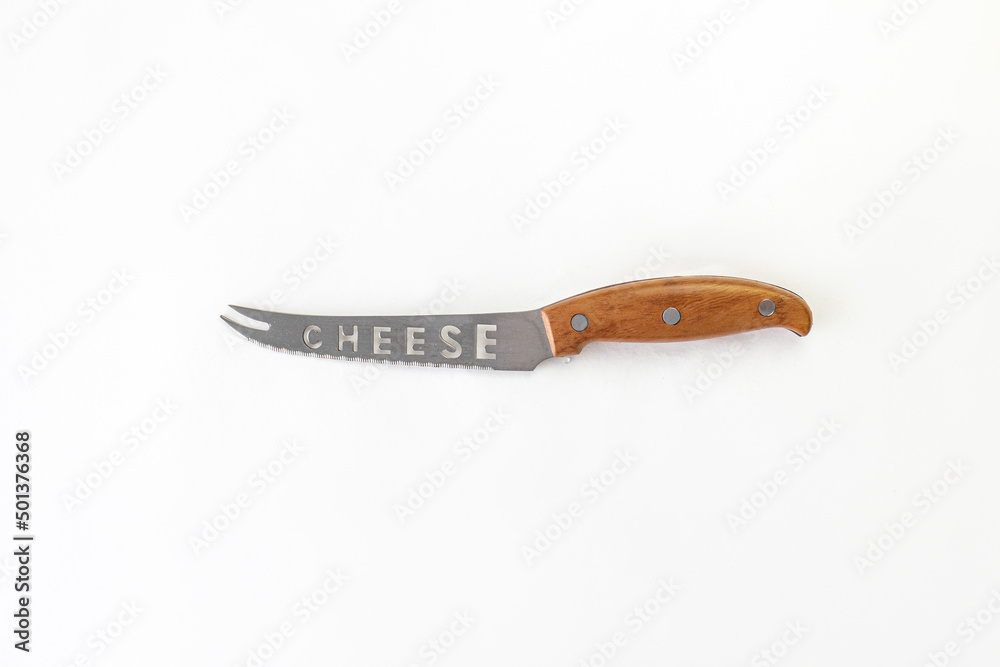 Kitchen chef knive for cheese laying on white background, flat lay, view from above, space for a text. Chef, restaurant or kitchen concept. Kitchen chef knive for cheese laying on white background, flat lay, view from above, space for a text. Chef, restaurant or kitchen concept.