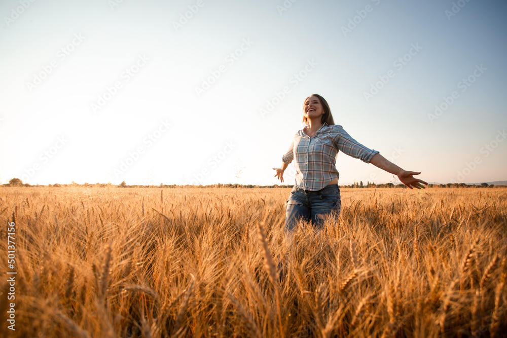 Woman with long hair in field at sunset Woman with long hair in field at sunset