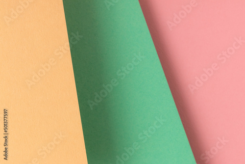 Paper background with yellow, turquoise and pink pastel colors.