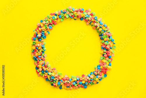 A multicolored circle on a yellow background.