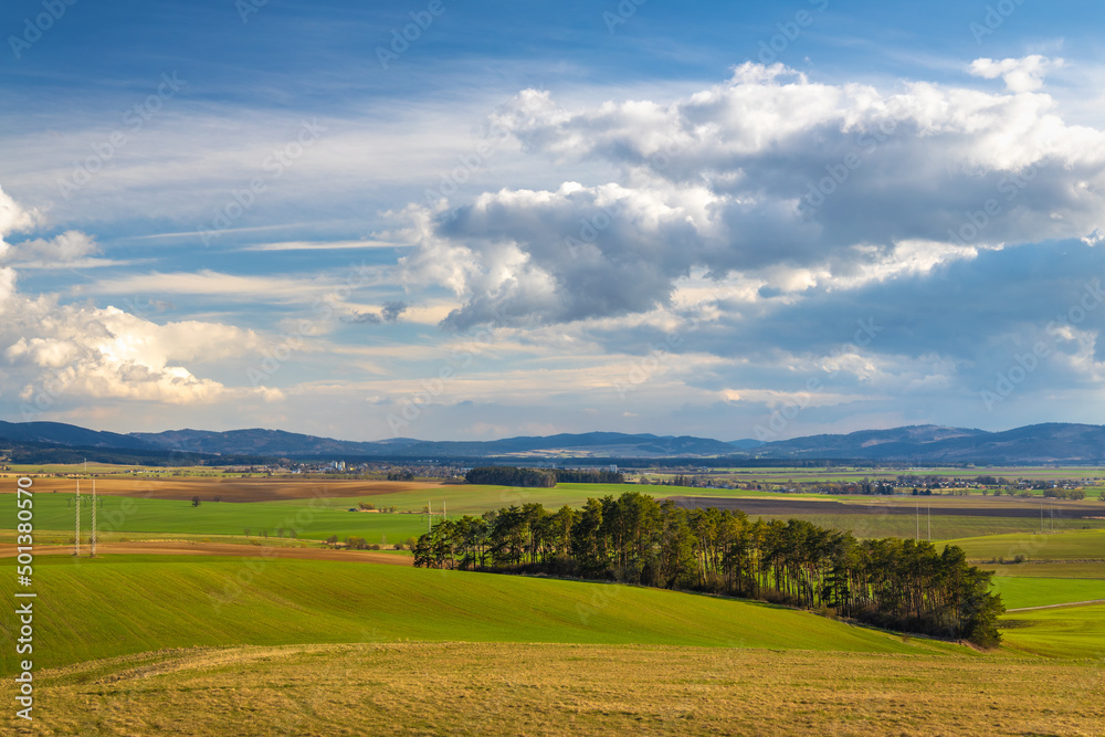Sunny spring rural landscape, valley of fields and meadows with mountains in the background. Turiec Valley in Slovakia, Europe. Sunny spring rural landscape, valley of fields and meadows with mountains in the background. Turiec Valley in Slovakia, Europe.