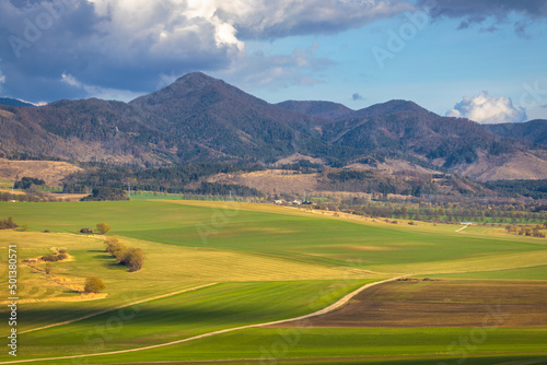 Sunny spring rural landscape, valley of fields and meadows with mountains in the background. Turiec Valley in Slovakia, Europe. © Viliam