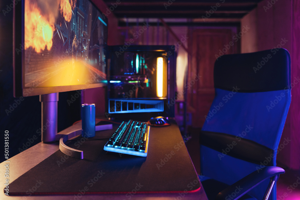 Cyber sport. Professional gaming PC setup and full RGB light inside. Gaming desktop, monitor, keyboard, gaming computer mouse, armchair. Neon coloured room of pro gamer, place playing video games Stock-foto