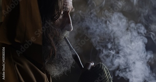 Fotobehang Bearded male hermit smoking pipe