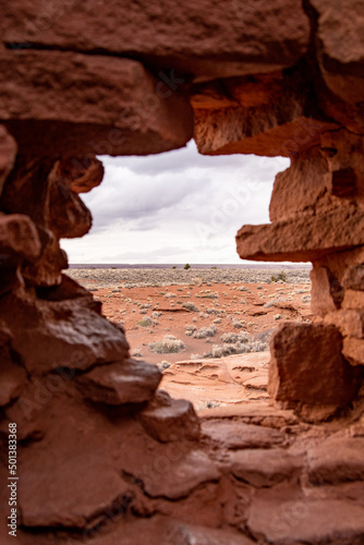 View of the Wapatki National Monument near the Petrified Forest National Park through a cliff hole photo