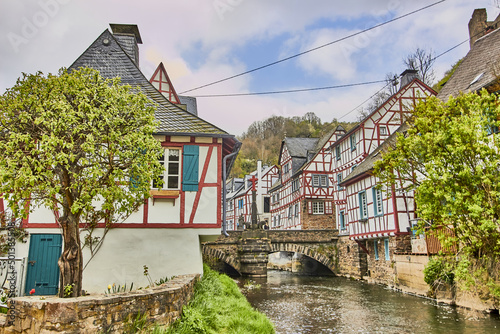 Photos Beautiful shot of a river bridge between houses in Monreal, Germany with a blue