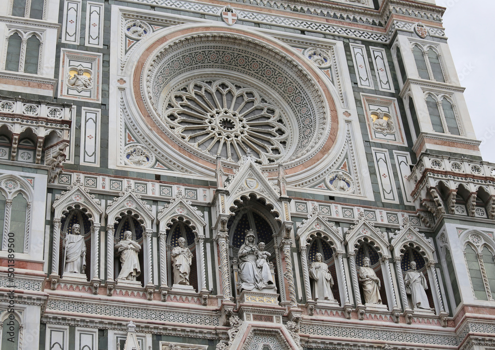 circular window. and statues of Saints in the  Cathedral of Florence in Italy called Santa Maria del fiore