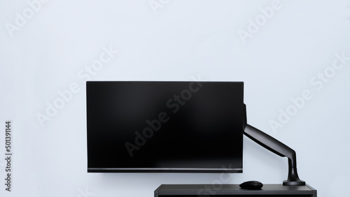 Εκτύπωση καμβά Modern thin computer monitor or TV set is mounted on a metal swivel desktop bracket with a gas lift function