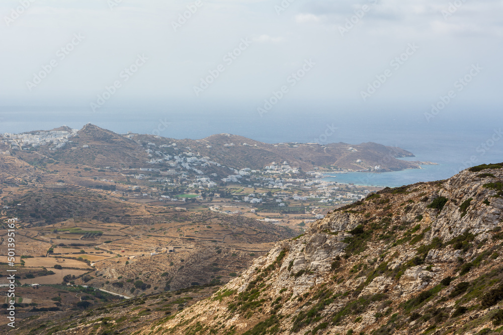 A view of the hazy west coast of Ios Island. Chora town and port in the background. Cyclades, Greece