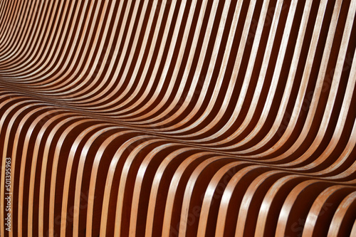 Curved wooden slats. Beautiful gradient from brown to green. Abstract background.
